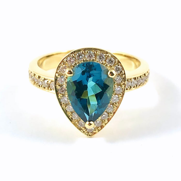 London blue topaz pear with diamond halo set in yellow gold ring